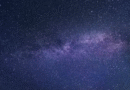 Stars visible in the night sky over a dark horizon