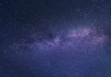 Stars visible in the night sky over a dark horizon